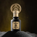 Black bottle gold cap oriental perfume Enta Habibti by Khalifi Perfumes on black sand with dark luminous background
